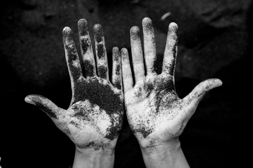 grayscale photo of person's hands