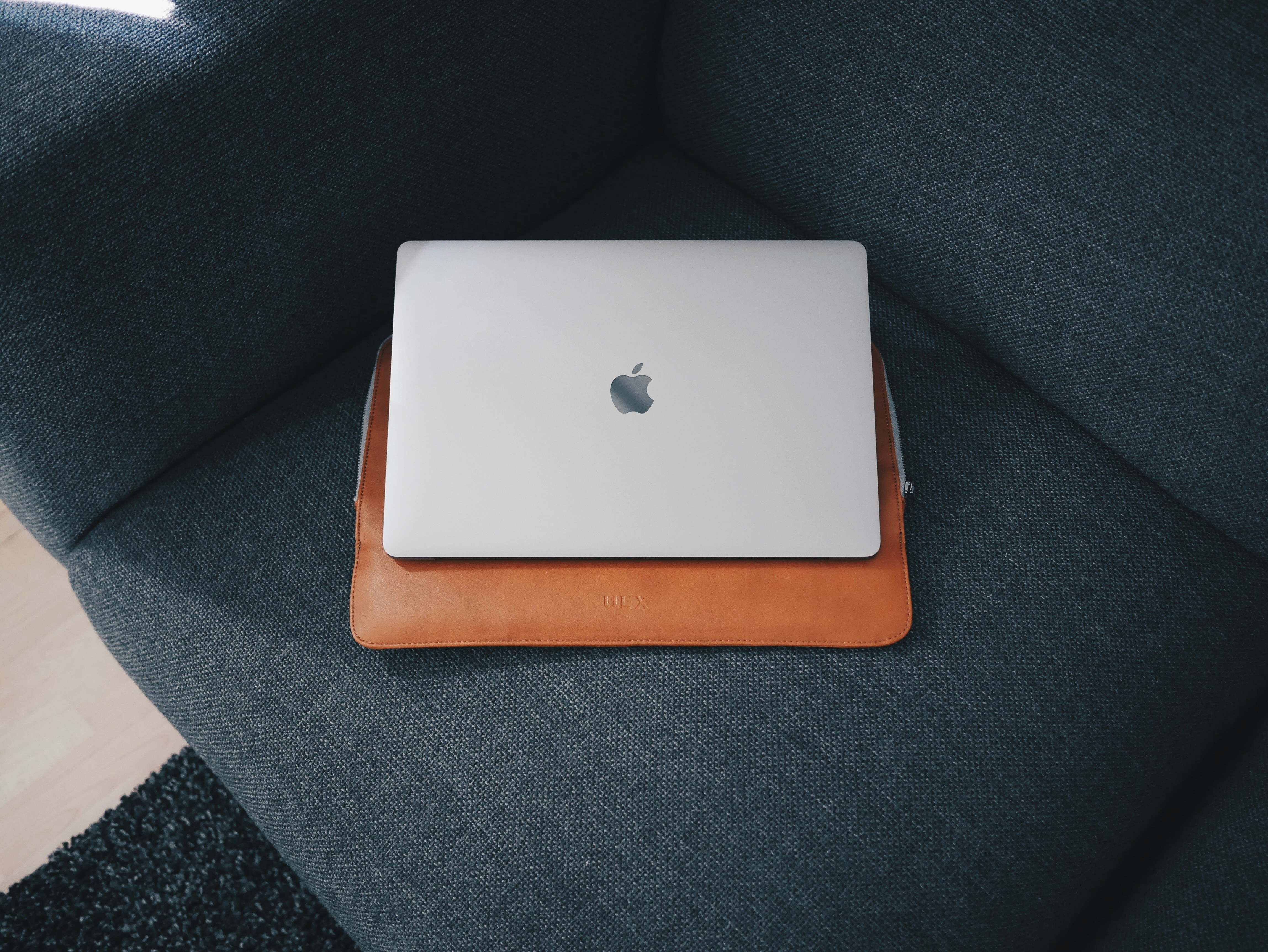 Apple MacBook on blue cushion, 