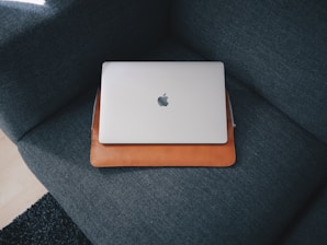 Apple MacBook on blue cushion