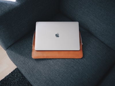 Apple MacBook on blue cushion