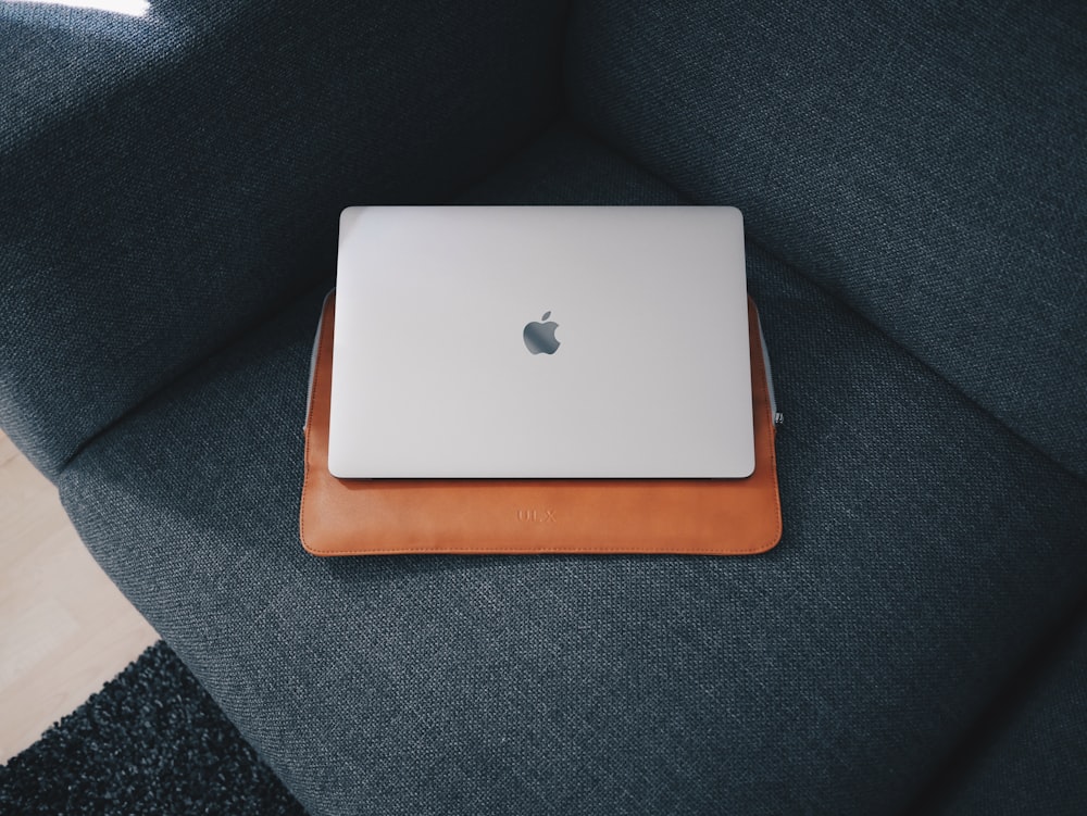 Apple MacBook on blue cushion