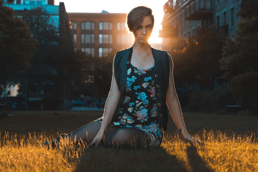 woman sitting on grass field