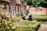 A smiling senior couple enjoying a sunny day in their garden.