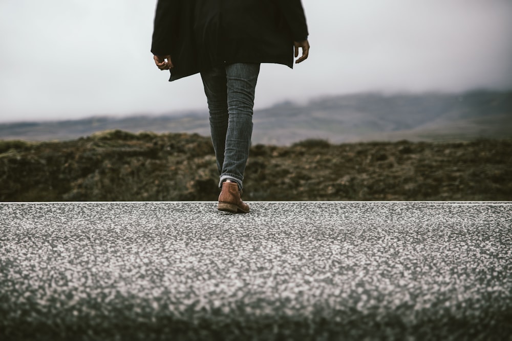 person walking near mountain during daytime