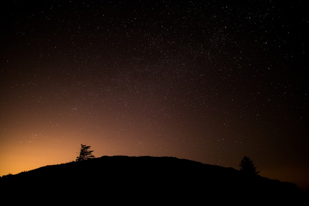 mountain silhouette during night time