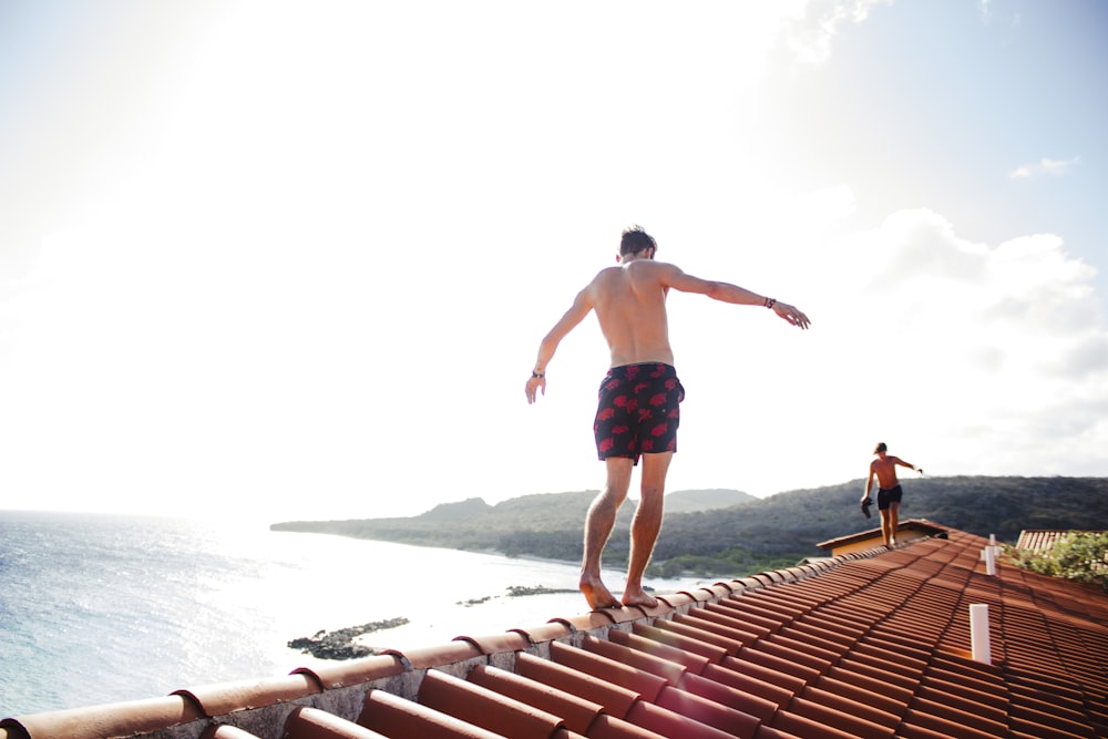 man walking on house roof