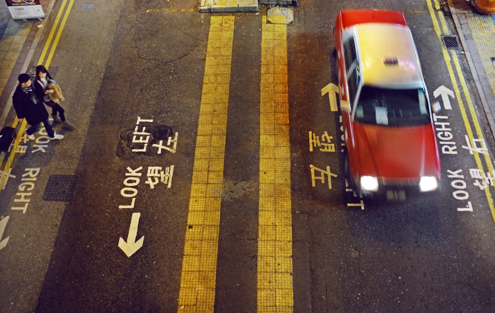 man and woman standing at the right side of the street