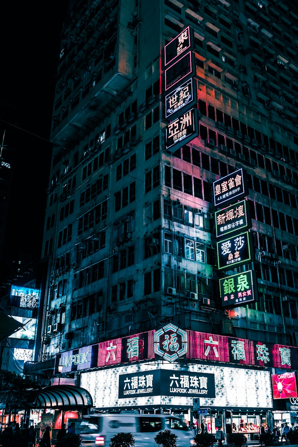 high-rise building with lighted neon signage