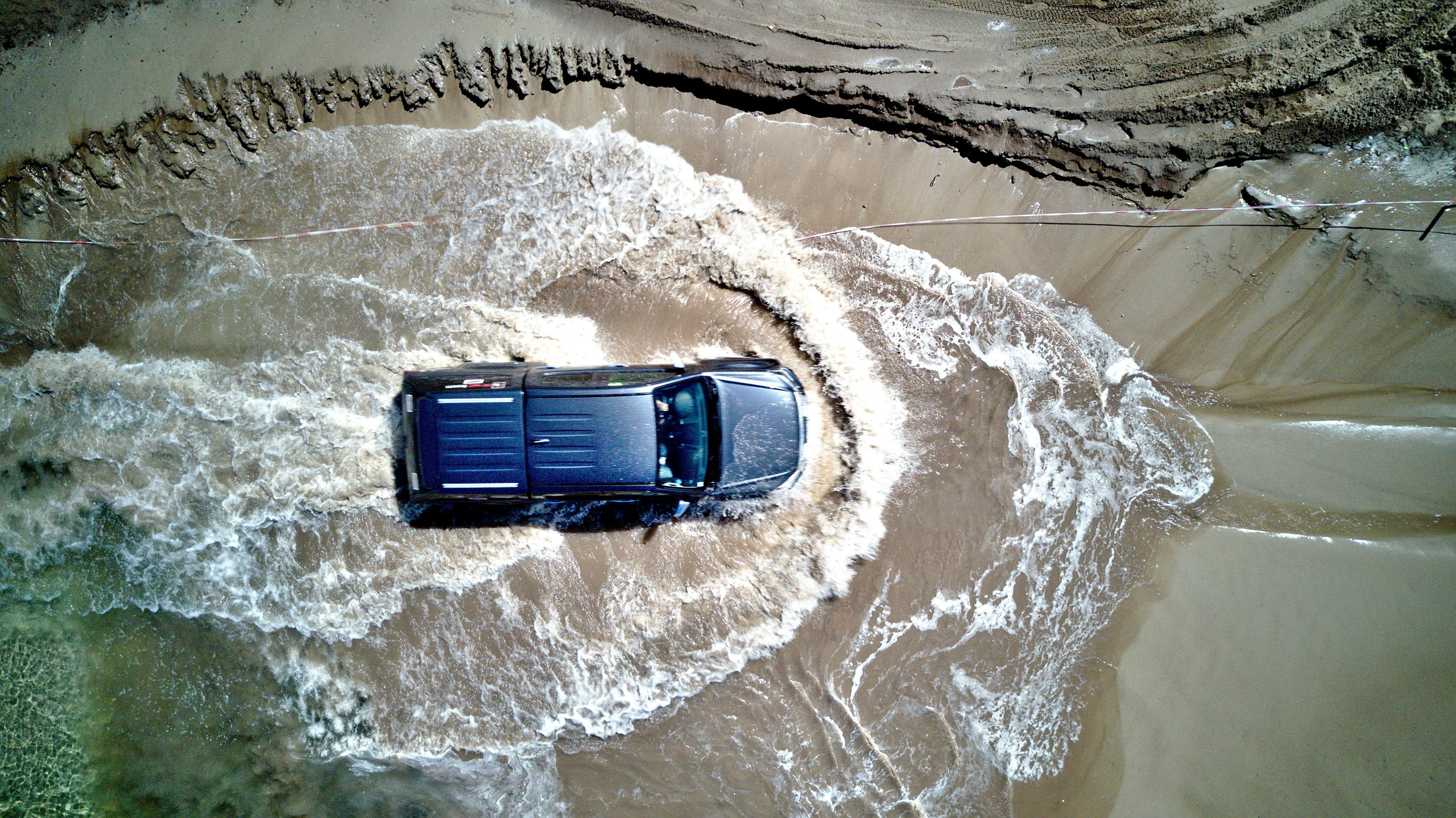 top view photography of pickup truck in puddle of water