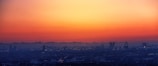 A panoramic view of a vibrant city skyline at sunset.