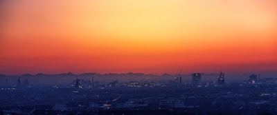 A panoramic view of a vibrant city skyline at sunset.