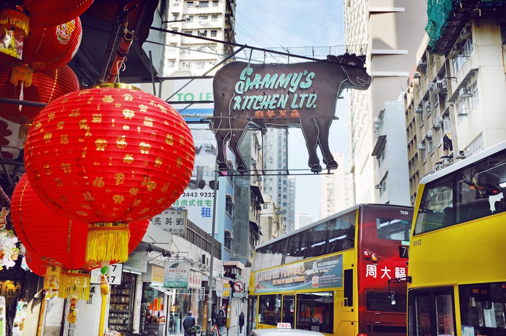 cow shop signage and two yellow buses in street