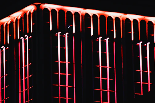 Close-up of a building facade featuring sharp angles and glowing neon outlines.