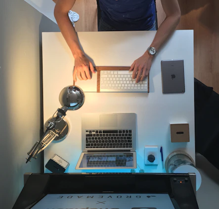 A calm workspace with a minimalist keyboard and a sleek laptop displaying typing practice in progress.