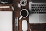 cup of coffee near MacBook Pro