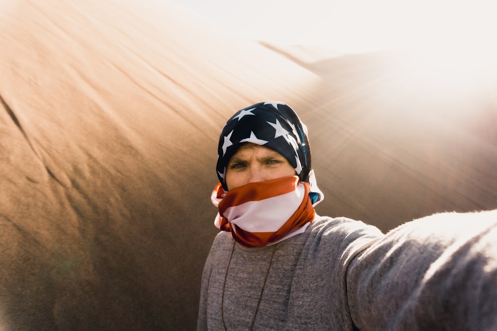 man covering his face with textile