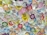 Close-up of colorful contour-cut stickers arranged artistically on a wooden table.
