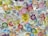 A close-up of colorful peel and stick tattoos displayed on a wooden table.