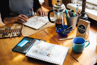 person holding book with sketch