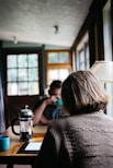 person sitting in front of table with coffee press