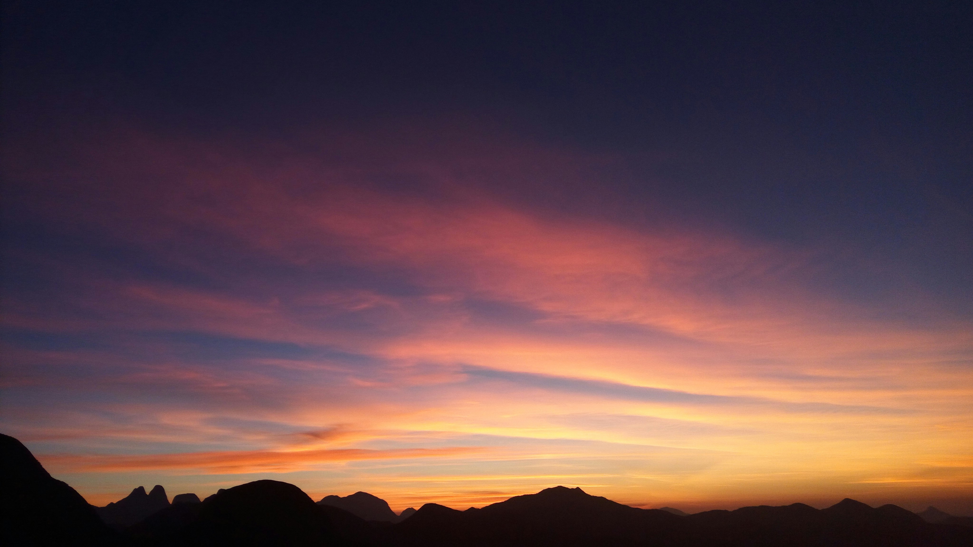 silhouette of mountains under calm sky