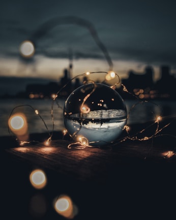 A sophisticated crystal ball illuminated by soft golden light.