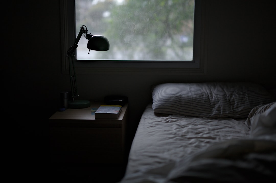 photo of bed near task lamp
