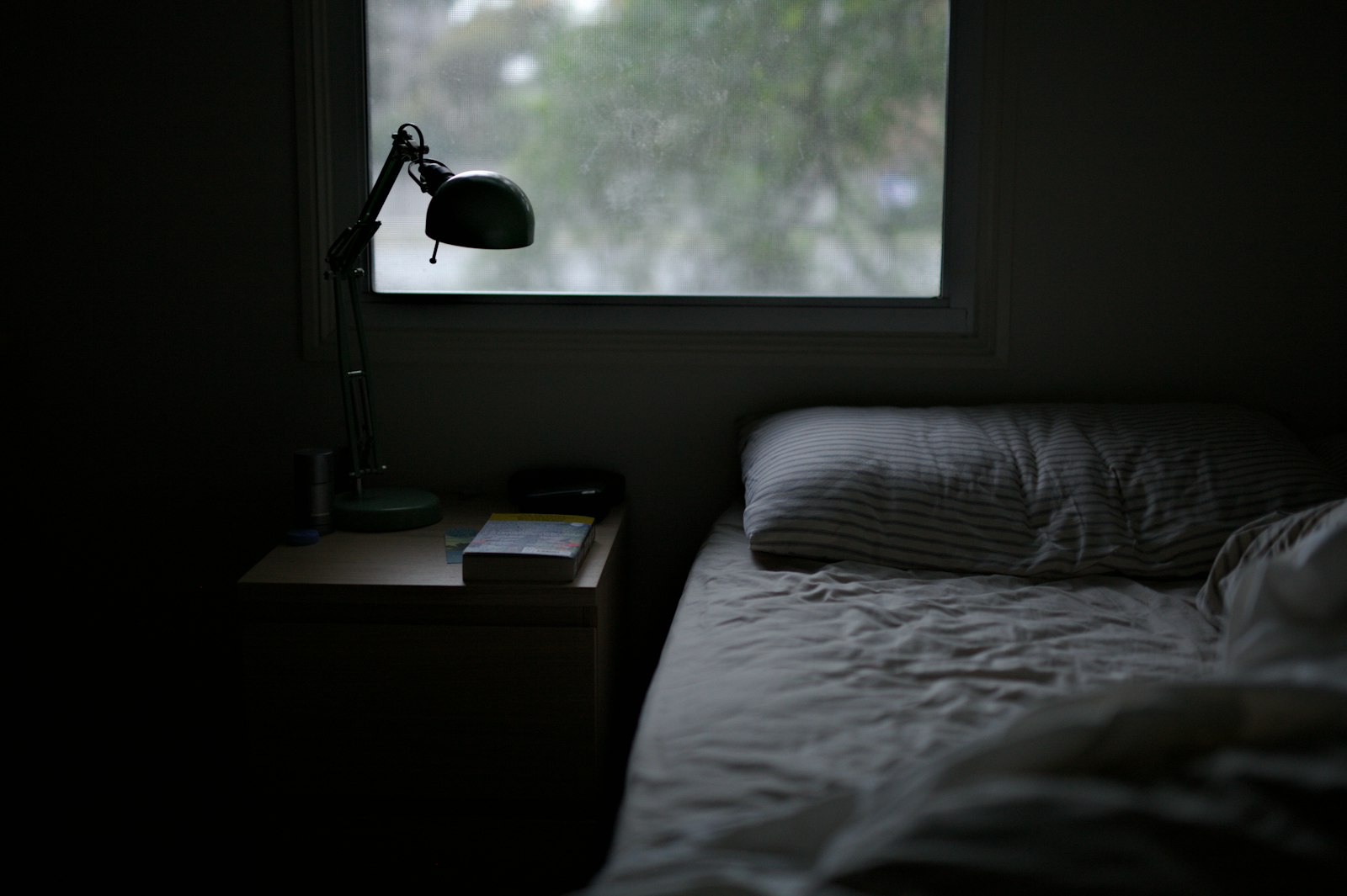 A dim bedroom at night — when leg cramps most often interrupt sleep