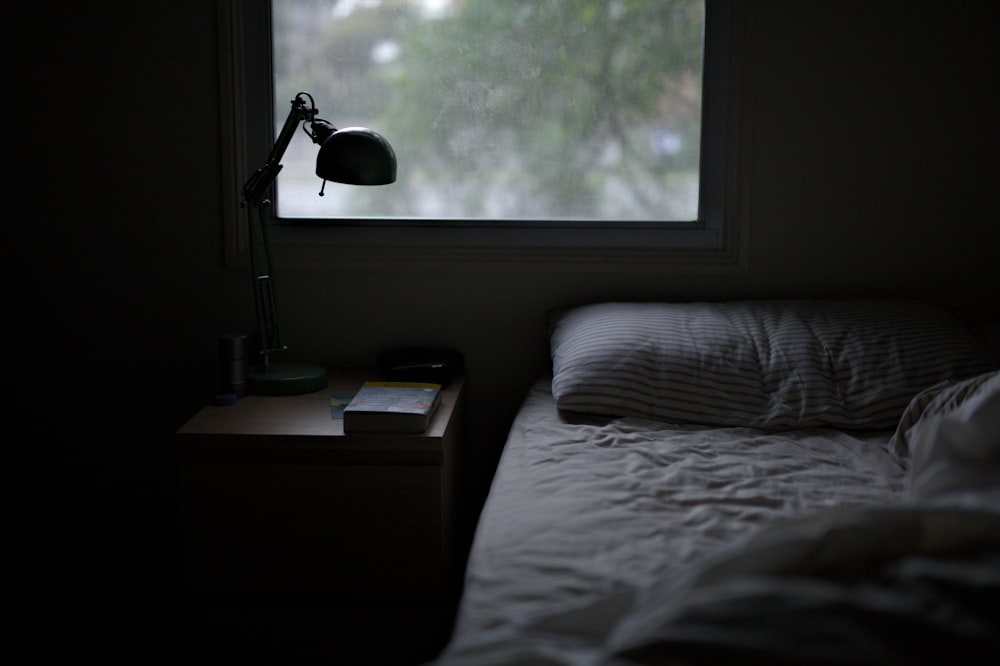 photo of bed near task lamp