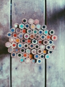 A collection of completed colored pencil drawings ready for sale.