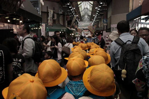 A group enjoying a guided tour in a vibrant local market, smiling and engaged.