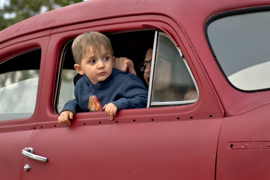 toddler riding on red vehicle in Santa Maria United States