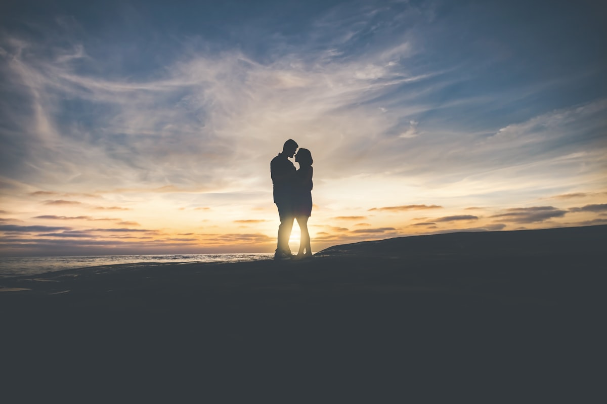 A romantic couple walking together at golden hour