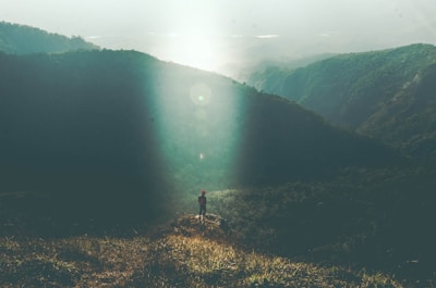 Simon pausing to catch his breath on a hilltop overlooking a valley.