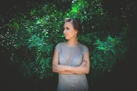 Elegant model posing outdoors in a stunning haute couture dress with natural light.