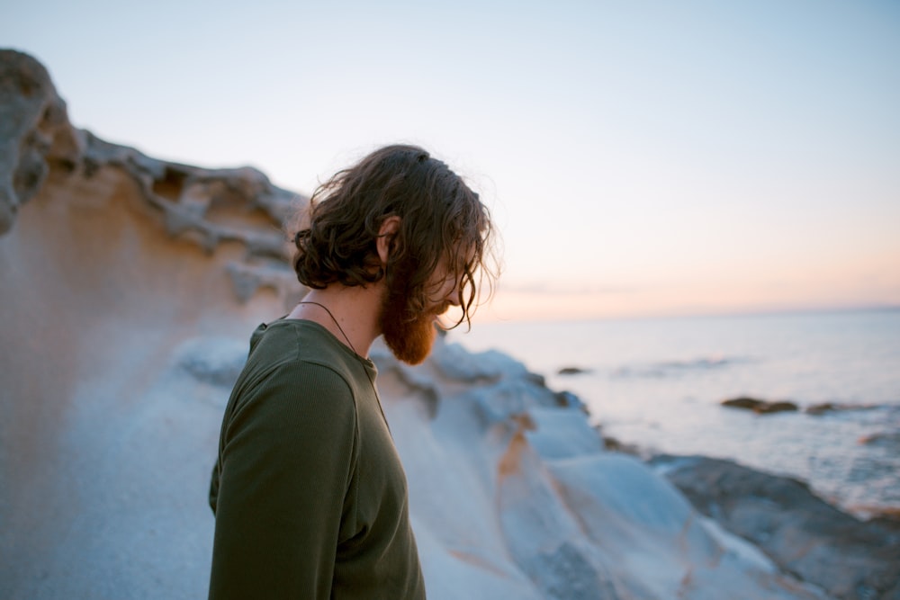 man in green shirt on seaside