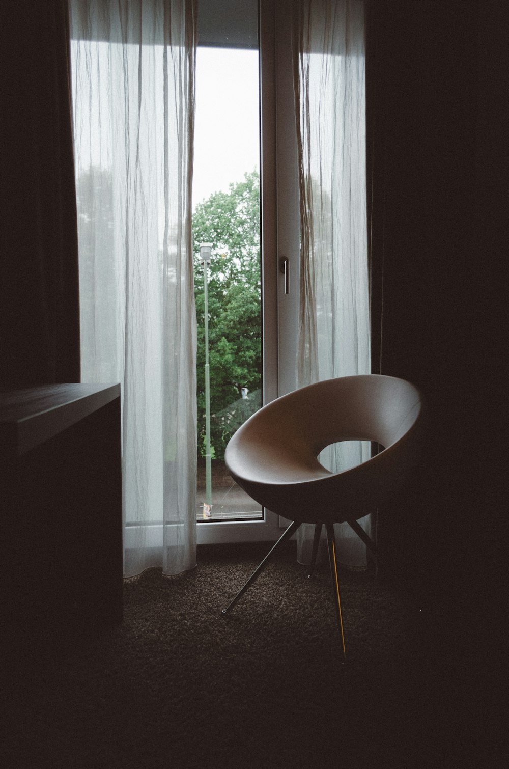 brown chair beside glass door