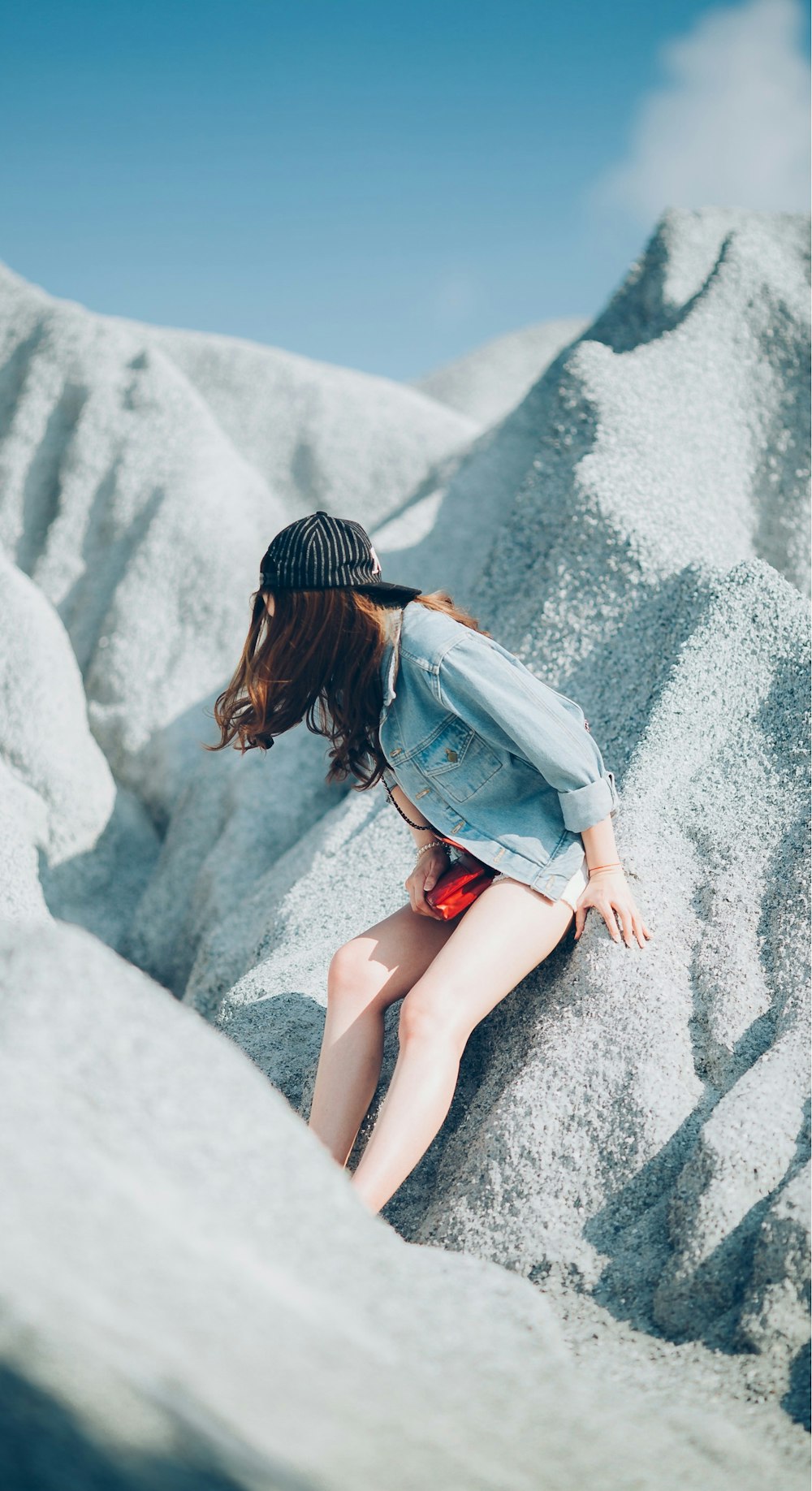 woman leaning on boulder looking on sideway