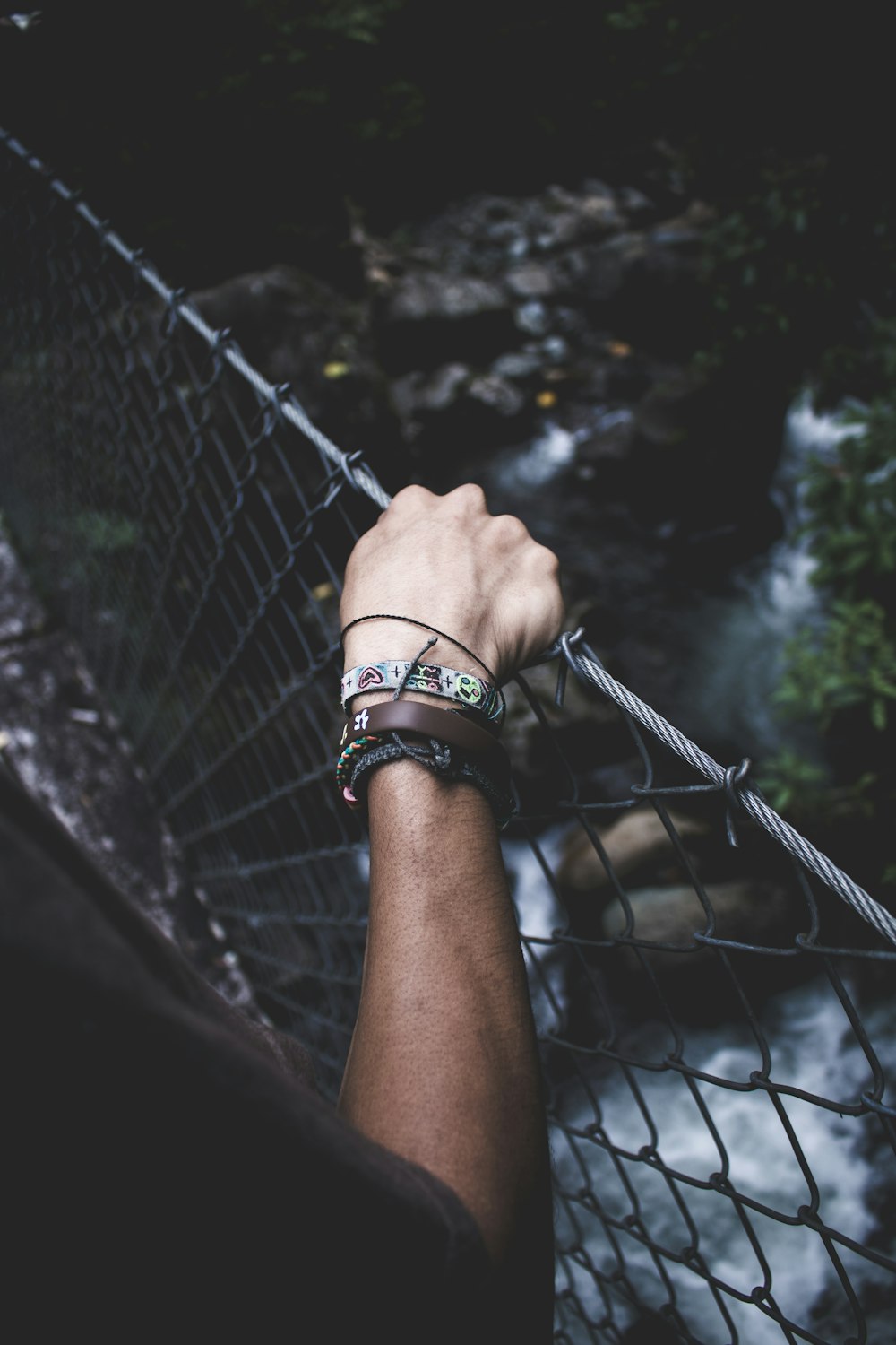 person crossing hanging bridge