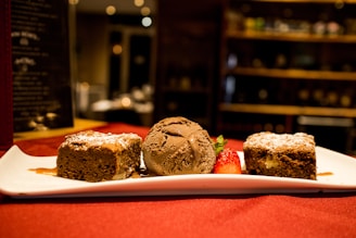 A minimalist dessert plate featuring a single chocolate mug cake with a dusting of powdered sugar.