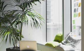 silver MacBook on top of table