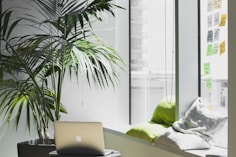 silver MacBook on top of table