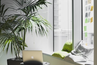 silver MacBook on top of table