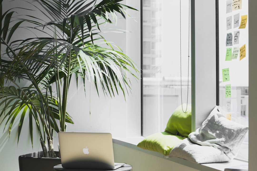 silver MacBook on top of table