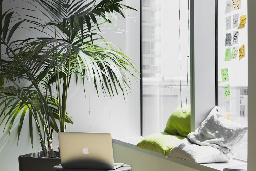 silver MacBook on top of table