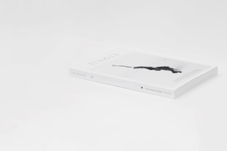 A sleek magazine lies on a white surface, titled 'Jungle 02.' The cover features an artistic black silhouette of a panther. It has a minimalist design with a focus on white space around the edges.