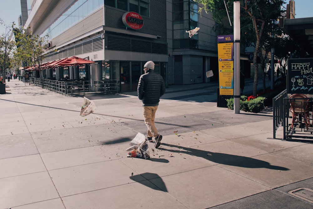 person in brown pants near concrete building