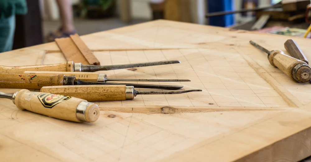 Interior of a small woodworking workshop with a bench and hand tools