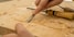 person using chisel while curving wood