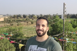 A friendly electrician smiling while standing outside a home at 992 E Boornazian Ave.